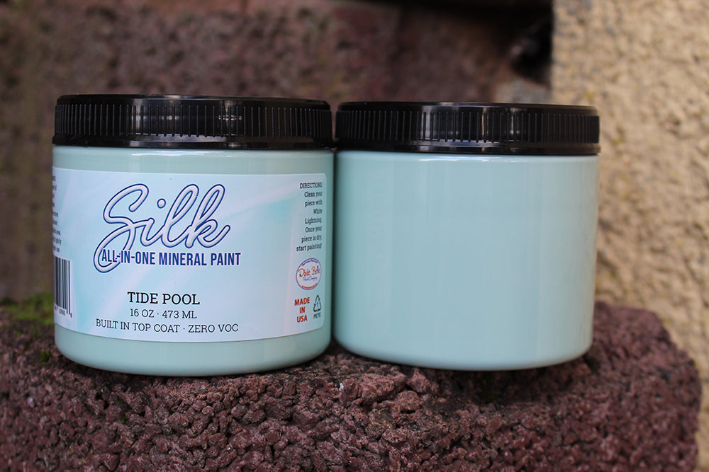 Peinture Silk de Dixie Belle. Couleur "Tide Pool" un vert-bleu très pâle. La peinture Silk All-In-One est une peinture crémeuse et auto nivelante en une seule étape. Il a un bloqueur de taches intégré (à base d'eau), un apprêt et une couche de finition. La peinture a une finition peu réfléchissante et est résistante à la moisissure. Vous pouvez utiliser cette peinture à l'intérieur car elle est inodore et non toxique.